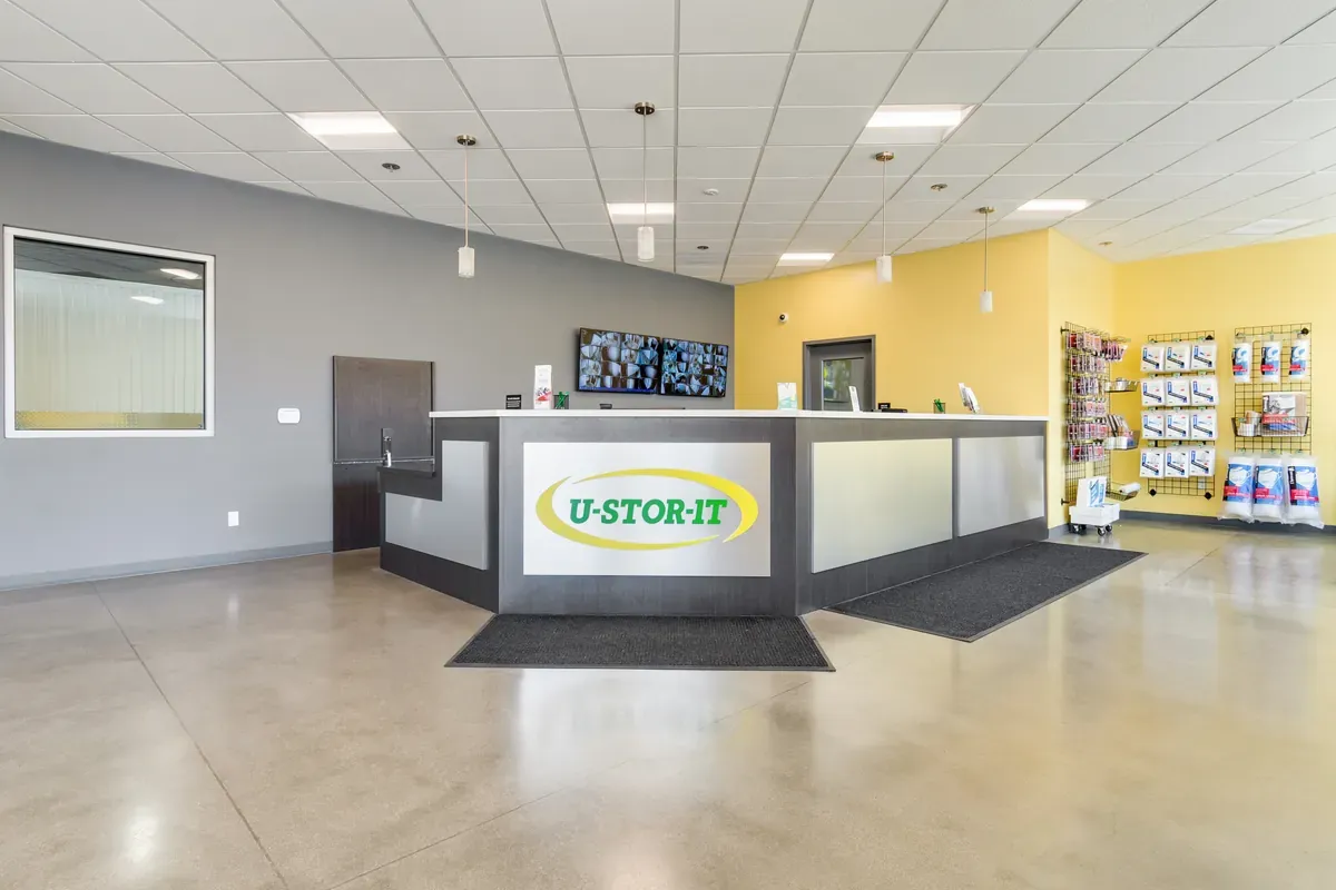 U-Stor-It rental office front desk featuring branded customer service counter and polished concrete floors.